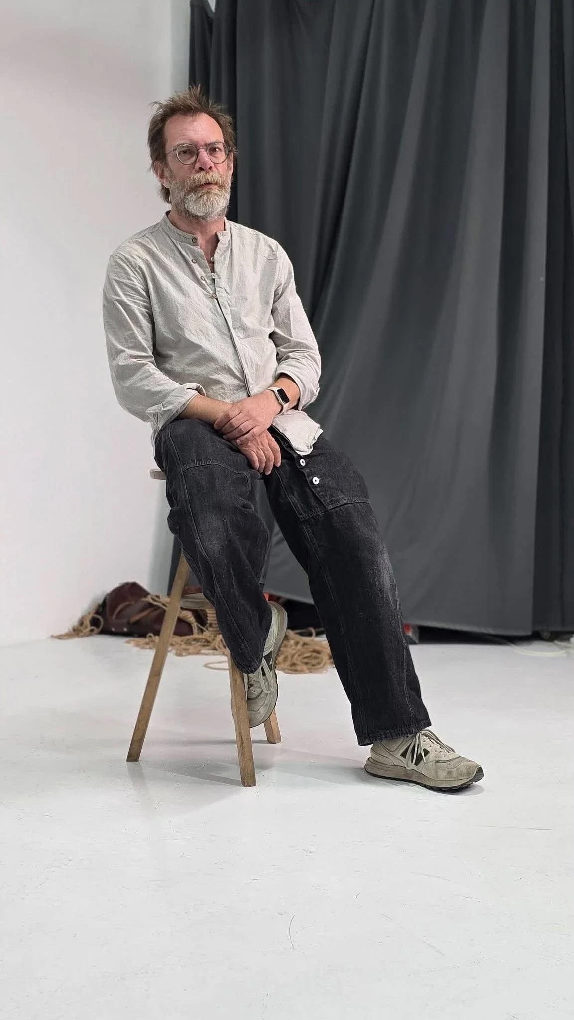 Roman, Ded Mazai, seated in a studio with shibari rope on the floor at one of his recent lectures.